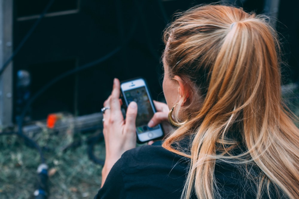 femme utilisant l’iPhone en plein air