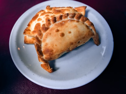 Freshly baked pastries arranged on a rustic ceramic plate with a warm background.