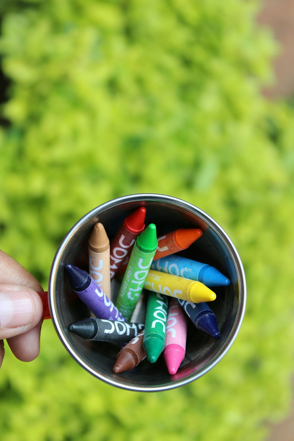 flat lay photography of crayons inside mug