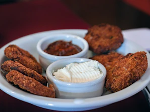 Assorted fried salgados with a crispy texture served with dipping sauce