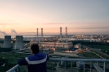 A vigilant fire watch guarding a busy industrial site at dusk