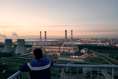 Wide shot of an industrial facility monitored by video fire detection cameras at dusk.