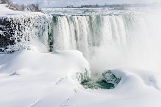 landscape photo of waterfall and snow during daytime in Niagara Falls Canada