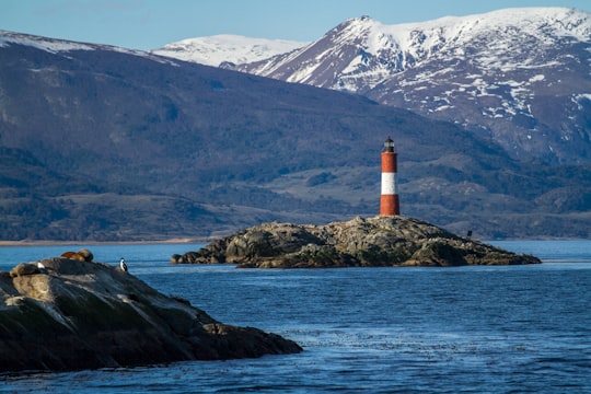 red and white lighthouse on island in Ushuaia Argentina