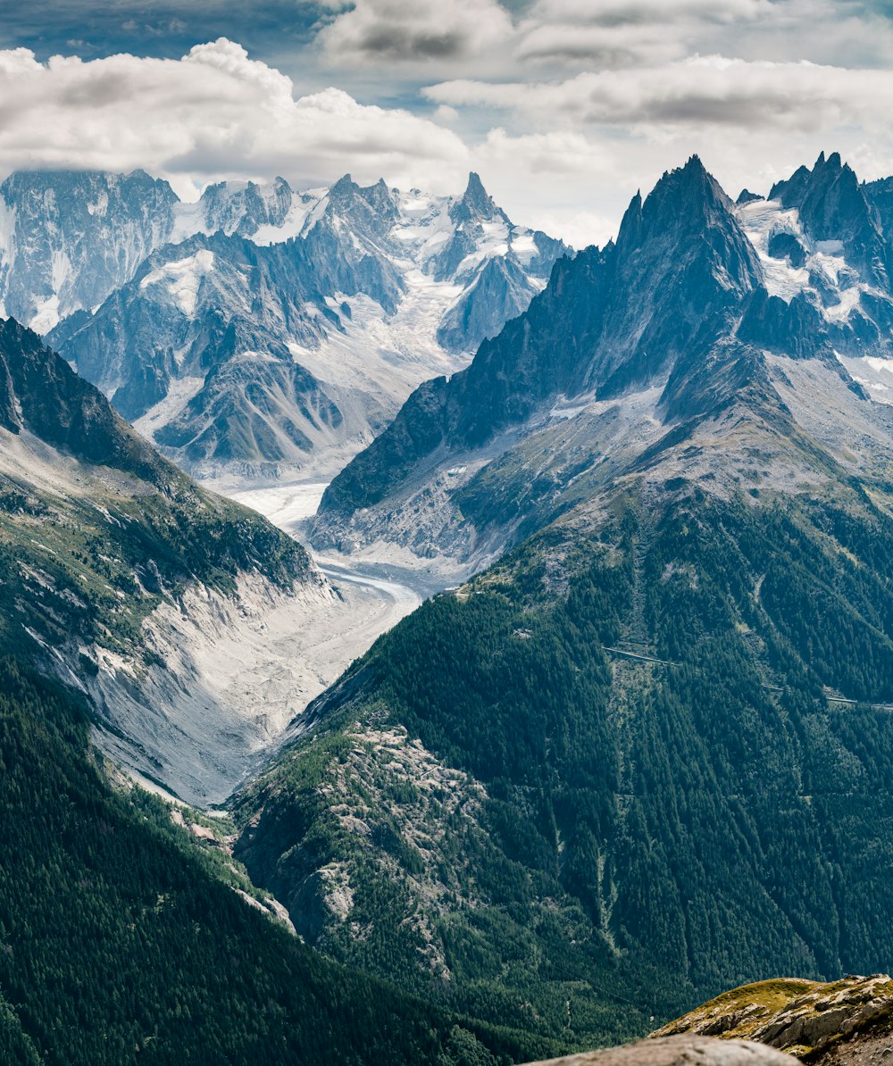 aerial view photography of mountains under cloudy sky