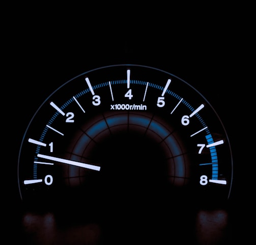 white and blue analog tachometer gauge