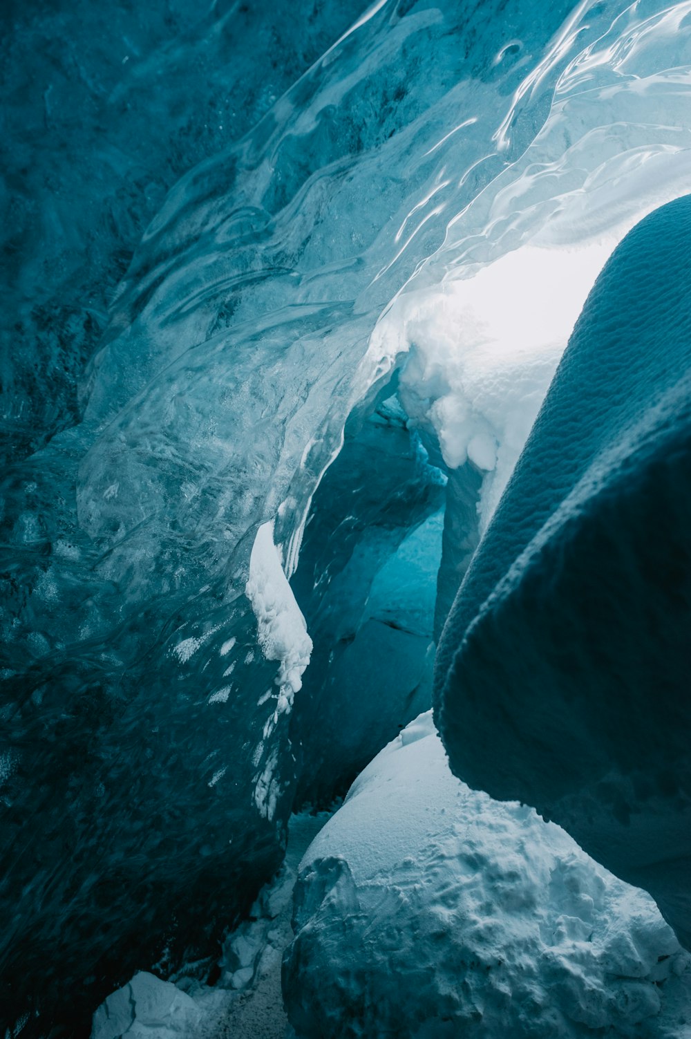 a large ice cave with water coming out of it