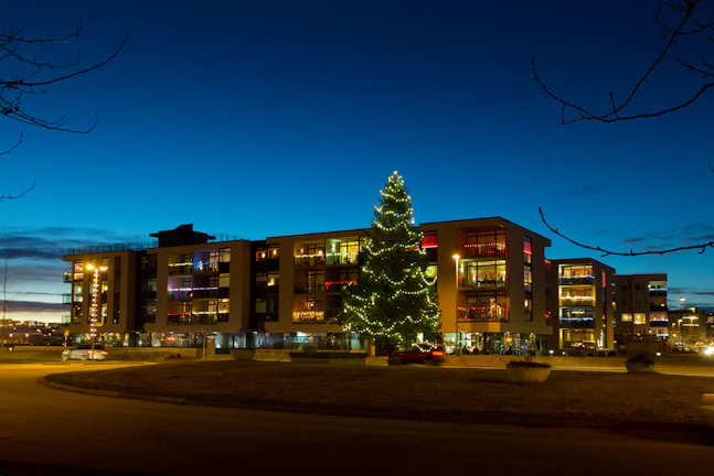 Evening view of the apartment complex beautifully lit with festive lights