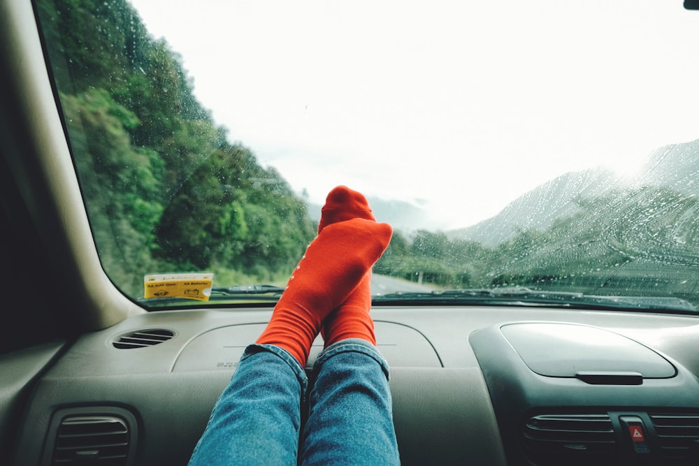 person wearing red socks near mountain
