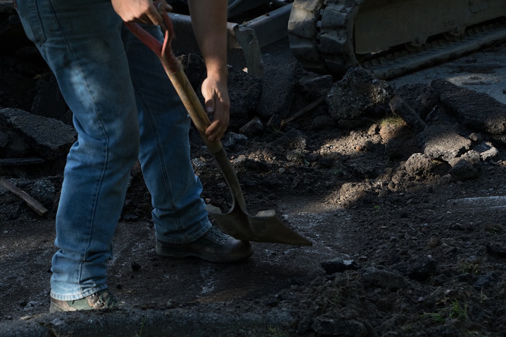 person holding brown wooden shovel