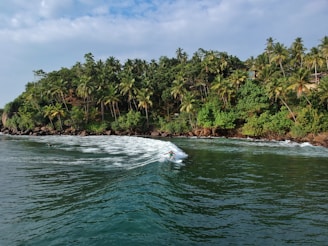 ocean waves towards island during daytime