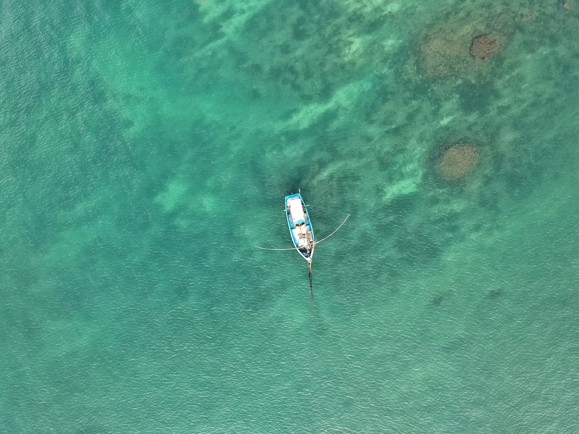 Small boat on the deep blue ocean off Sri Lanka