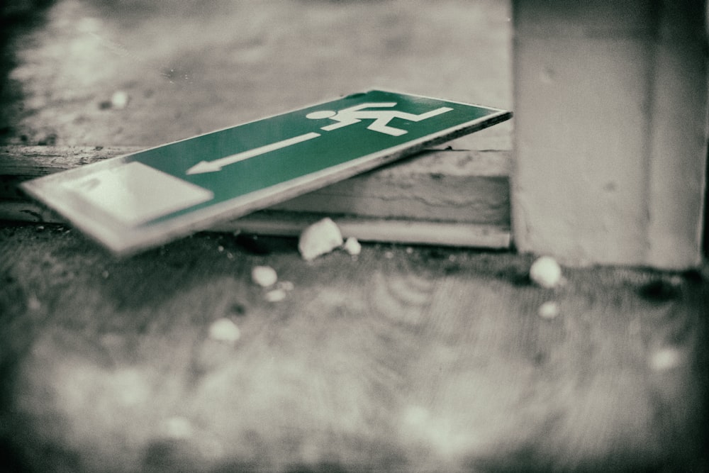 green sign board on ground