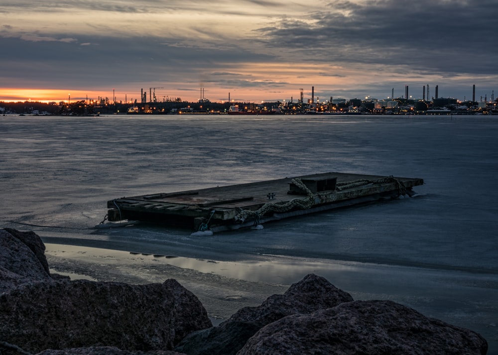 brown wooden boat on body of water