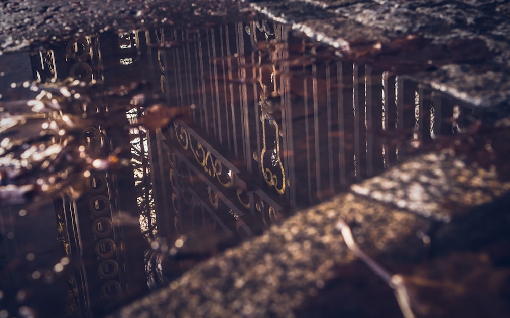 a reflection of a building in a puddle of water