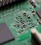 tilt-shift photography of green computer motherboard