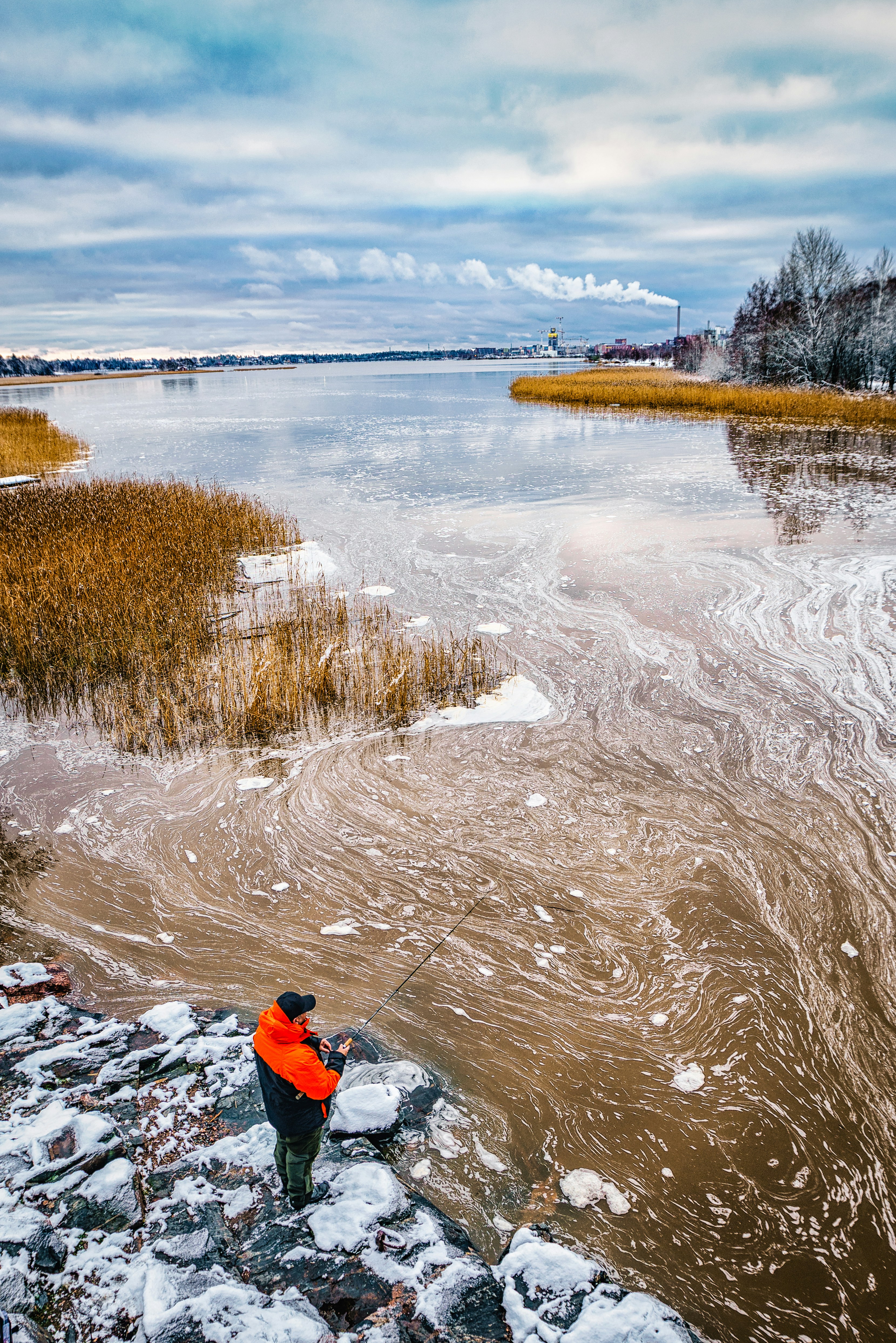 aerial photo of man fishing on body of water