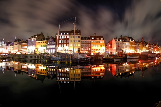 fish eye photo of buildings during night time in Nyhavn Denmark