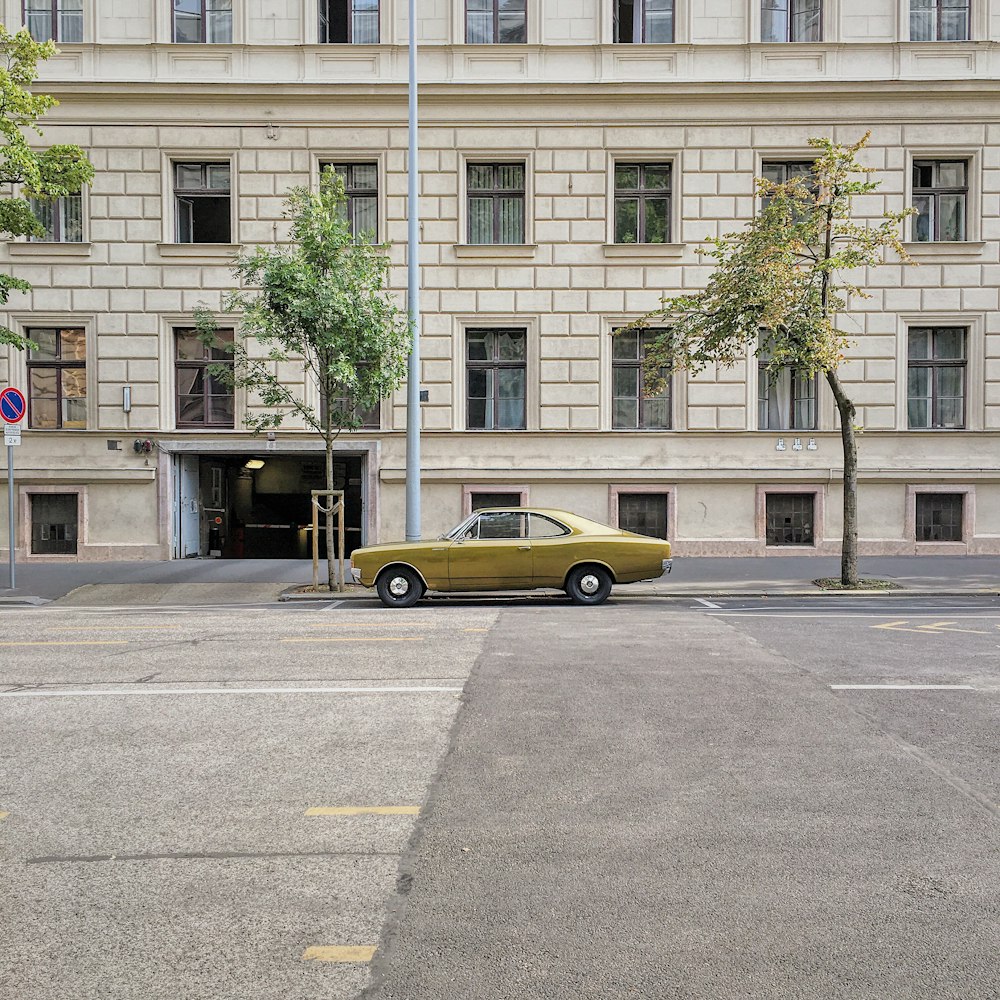 yellow sedan on concrete roadway