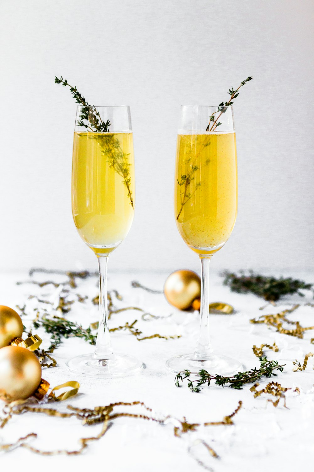 Fotografía de enfoque superficial de copas de champán rodeadas de bolas de oro