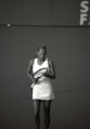 woman wearing dress holding tennis racket