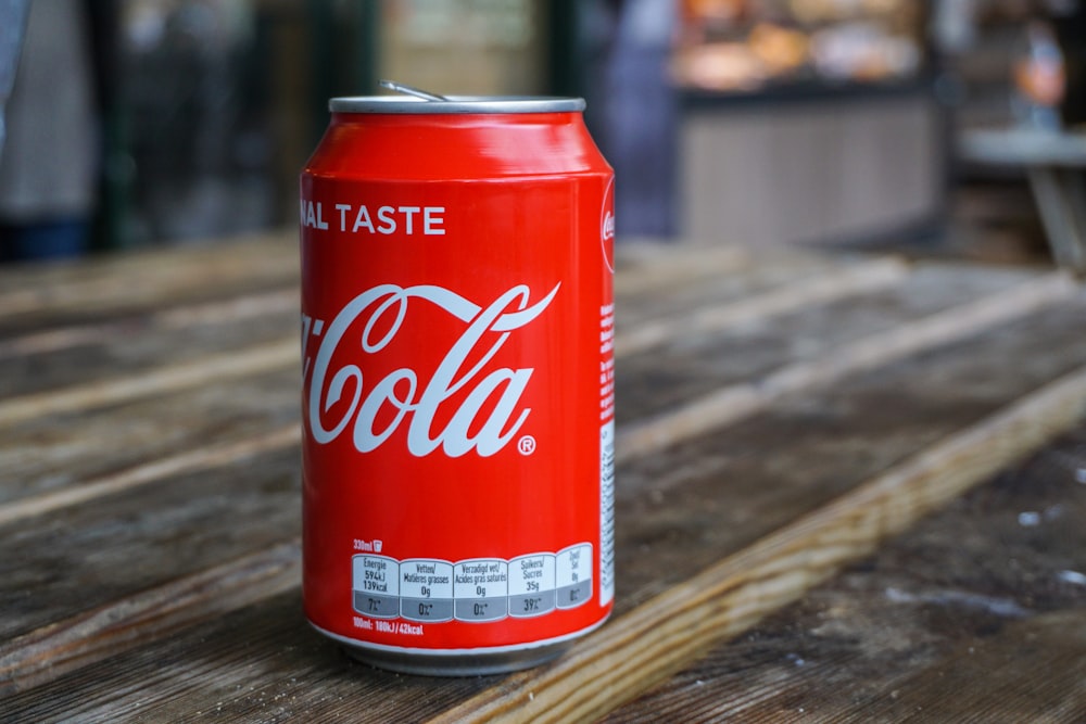 Coca-Cola can on brown wooden table