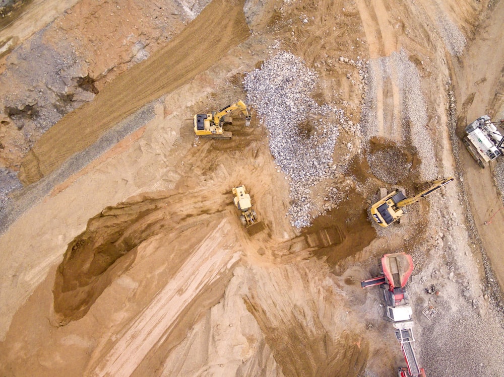 aerial photography of three heavy equipment