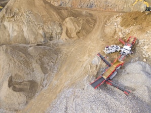 Sand and gravel pit with excavators loading trucks.