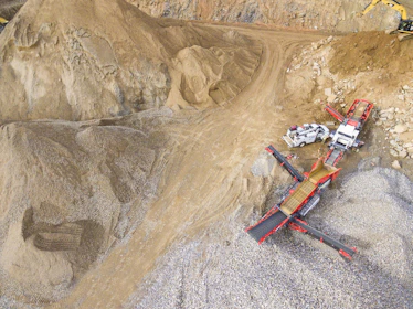 Close-up of crushed stone piles ready for delivery at the quarry site.