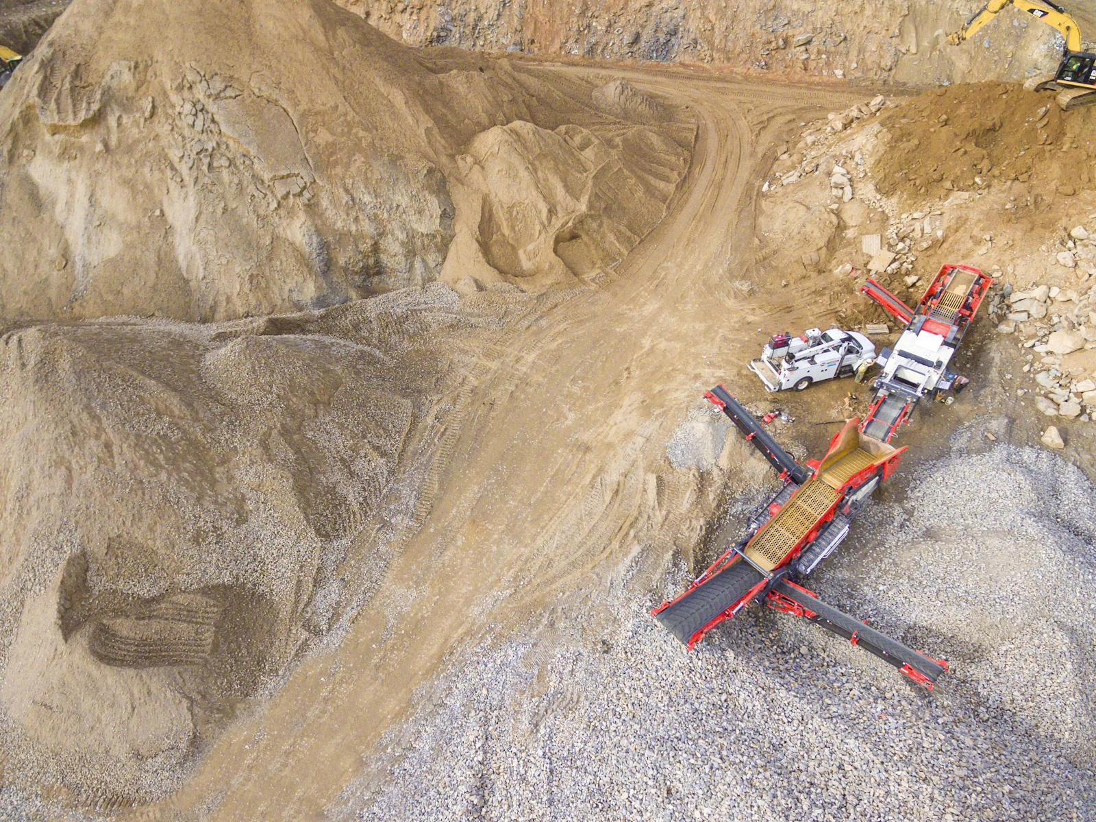 Aerial view of mining equipment and extraction pits, illustrating the small-scale and large-scale gold operations that drive a large share of Suriname's export earnings