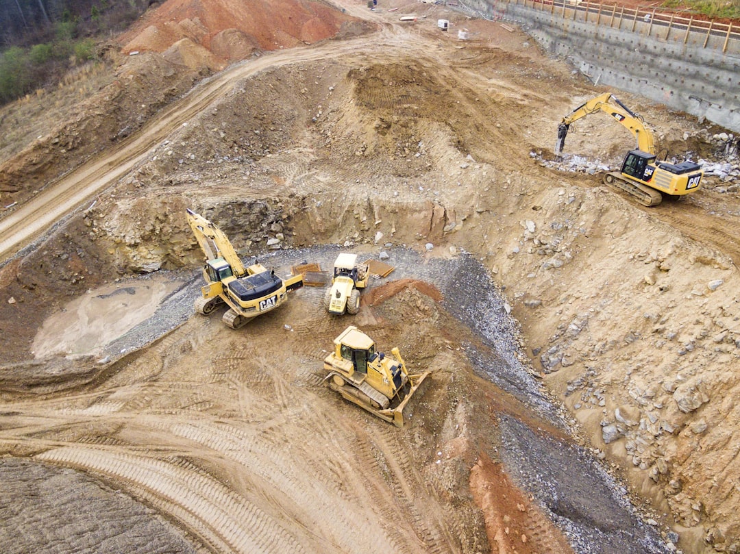 top view photography of four heavy equipment on quarry at daytime, JohnnyMcLendon.com<p></figure>Professional Drone Pilot and Commercial Photographer
