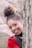 woman wearing black and red blazer hiding behind tall tree while smiling during daytime