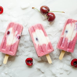 pink Popsicle with cherries on ice