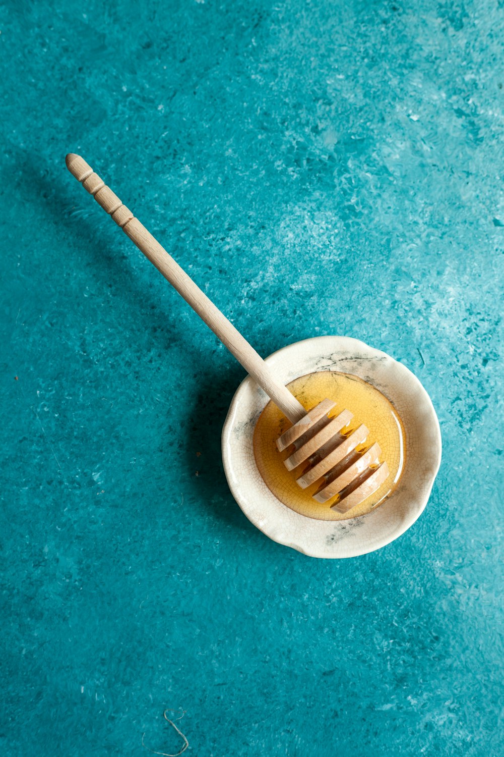 brown wooden stick on beige ceramic bowl