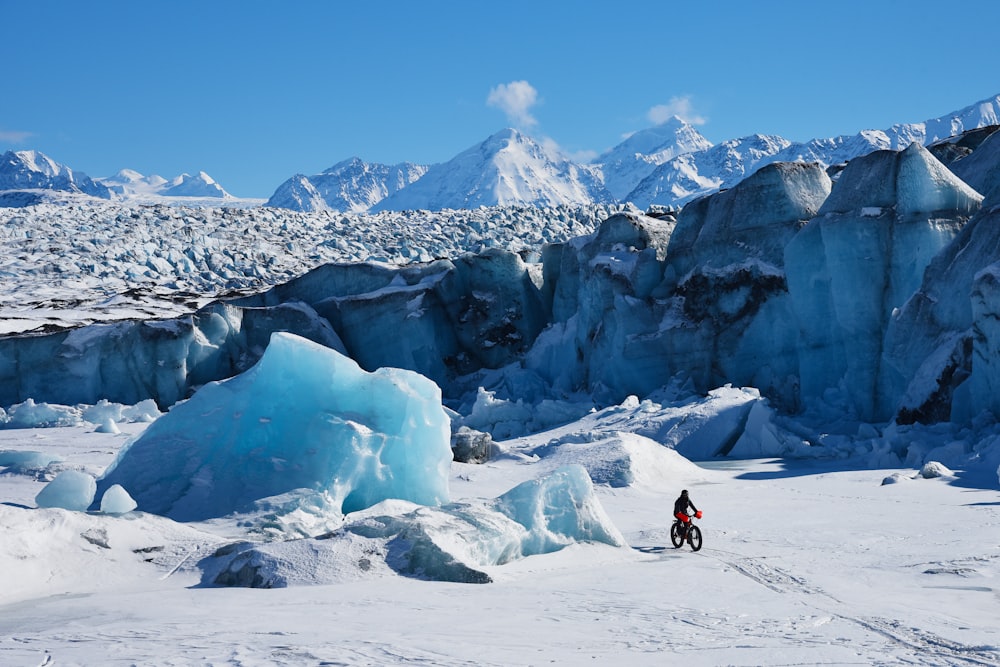 man using bicycle on snow