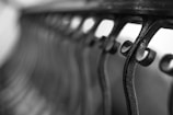 Curved, ornate wrought iron bars create a repeating pattern, with a shallow depth of field creating an artistic blur in the background.