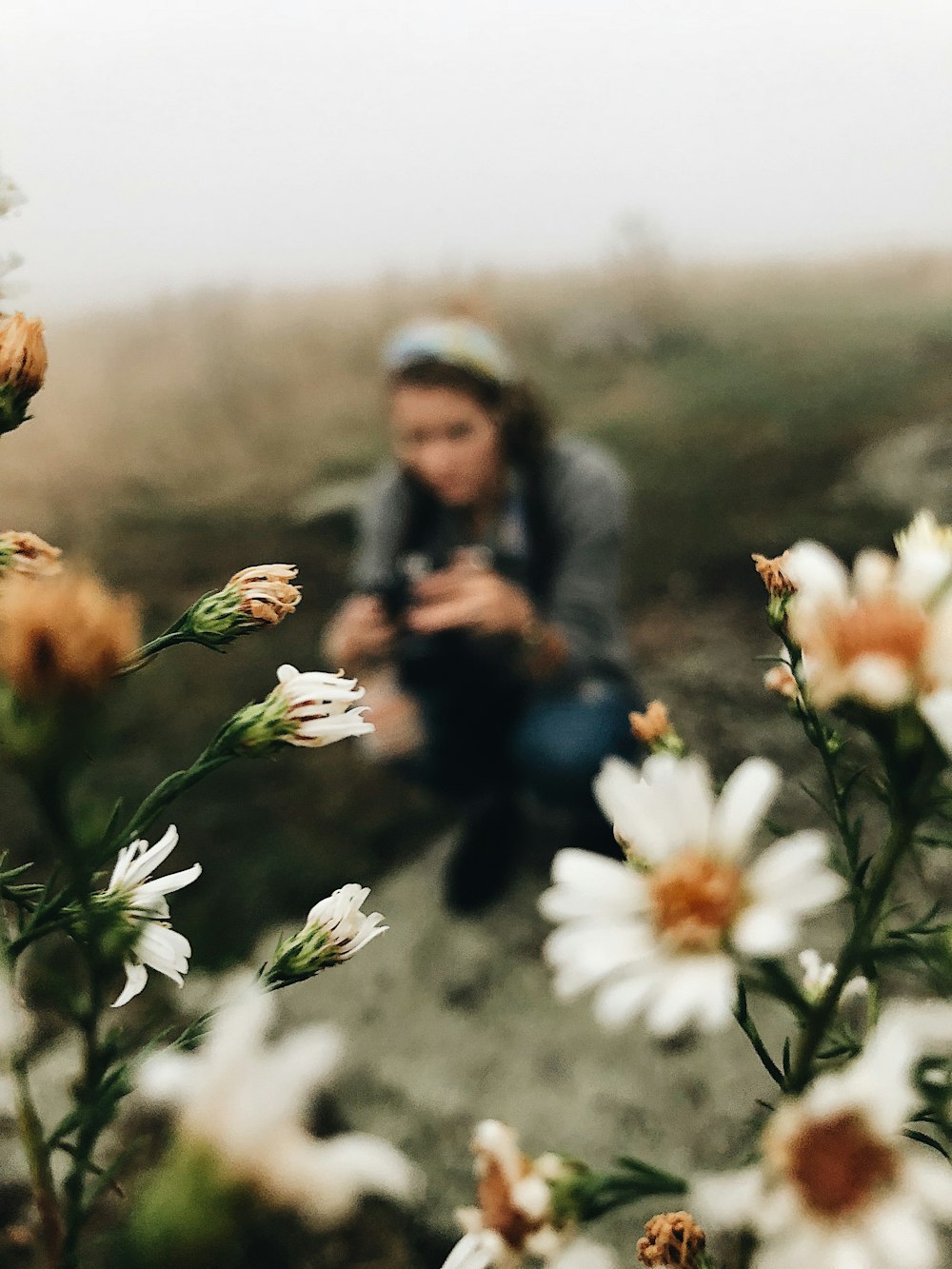 shallow focus photo of woman and flowers