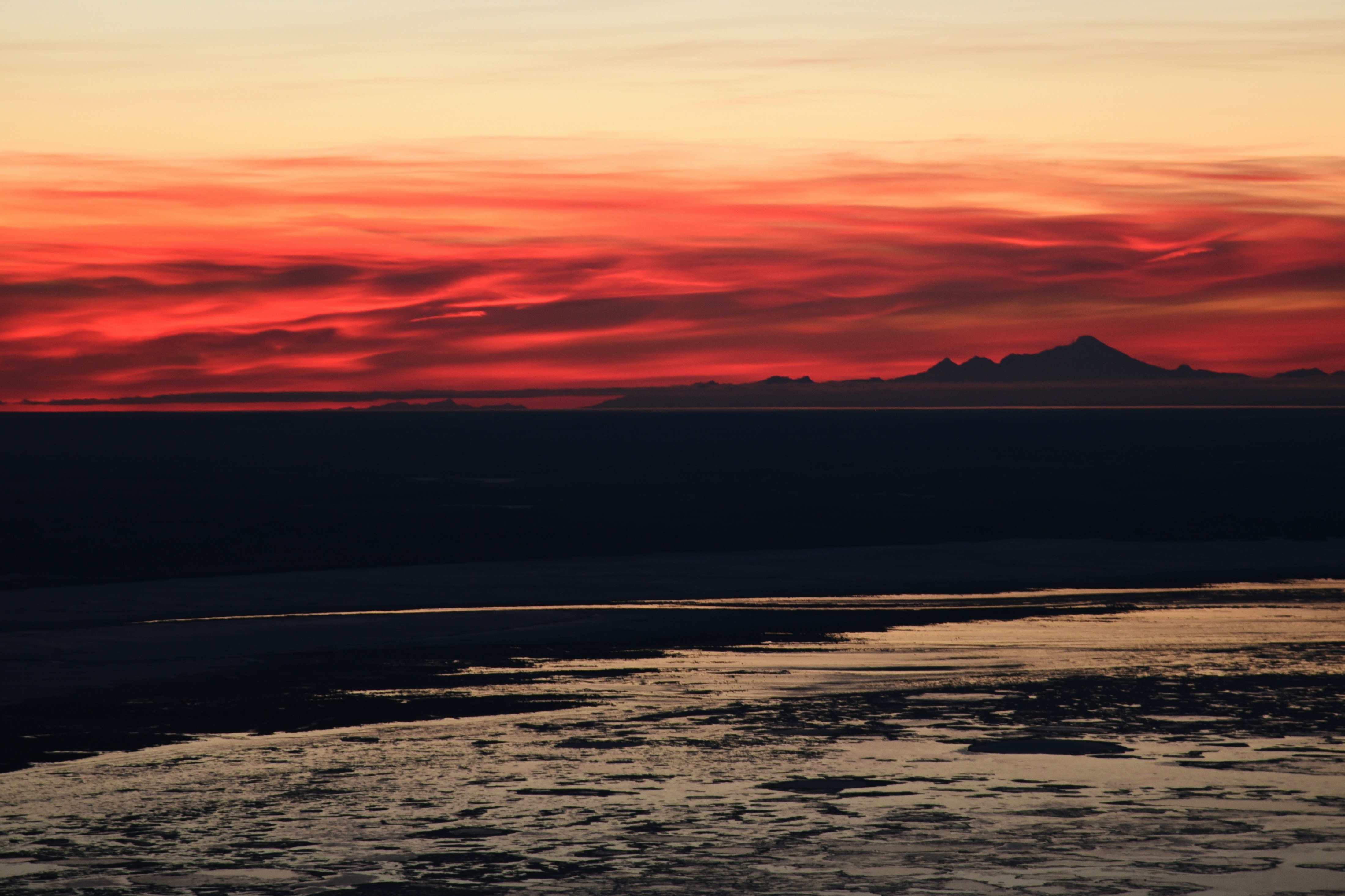 On our way to a winter campsite on the west summit of McHugh Peak, we were treated to this incredible swirling pink sunset behind Mt. Redoubt.