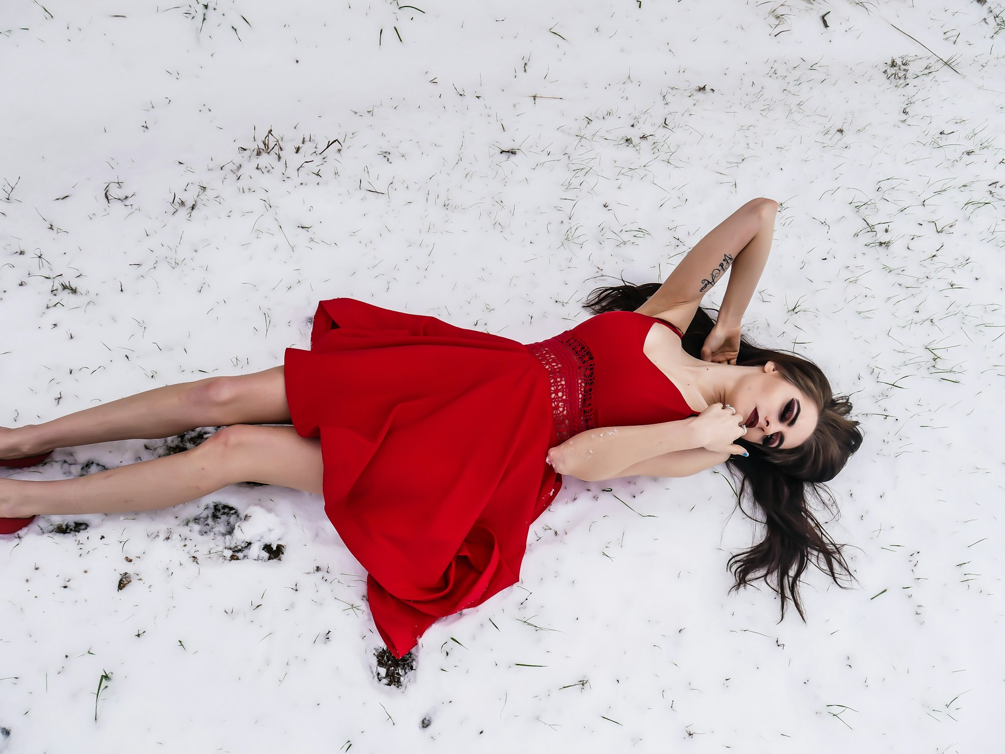 Here in East Texas, snow is rare. January of 2018 saw the most snowfall in 7 years, so I knew I needed to get some photos, but my wife and I decided to take it a step further with a touch of hypothermia. I took dozens of shots until she bravely suggested a couple sitting and even laying in the snow, clad only in her pretty red summer dress. The contrast of the vivid red directly against the white snow had me instantly captivated and I took as many as possible during the few seconds she was willing to withstand the cold. There were dozens that turned out beautifully, but this was a favorite!