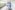 person walking on hallway in blue scrub suit near incubator