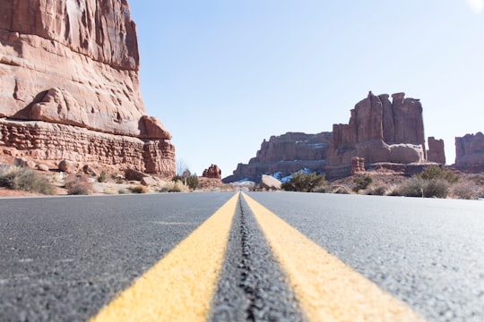 concrete pavement between rock formations in Arches National Park United States