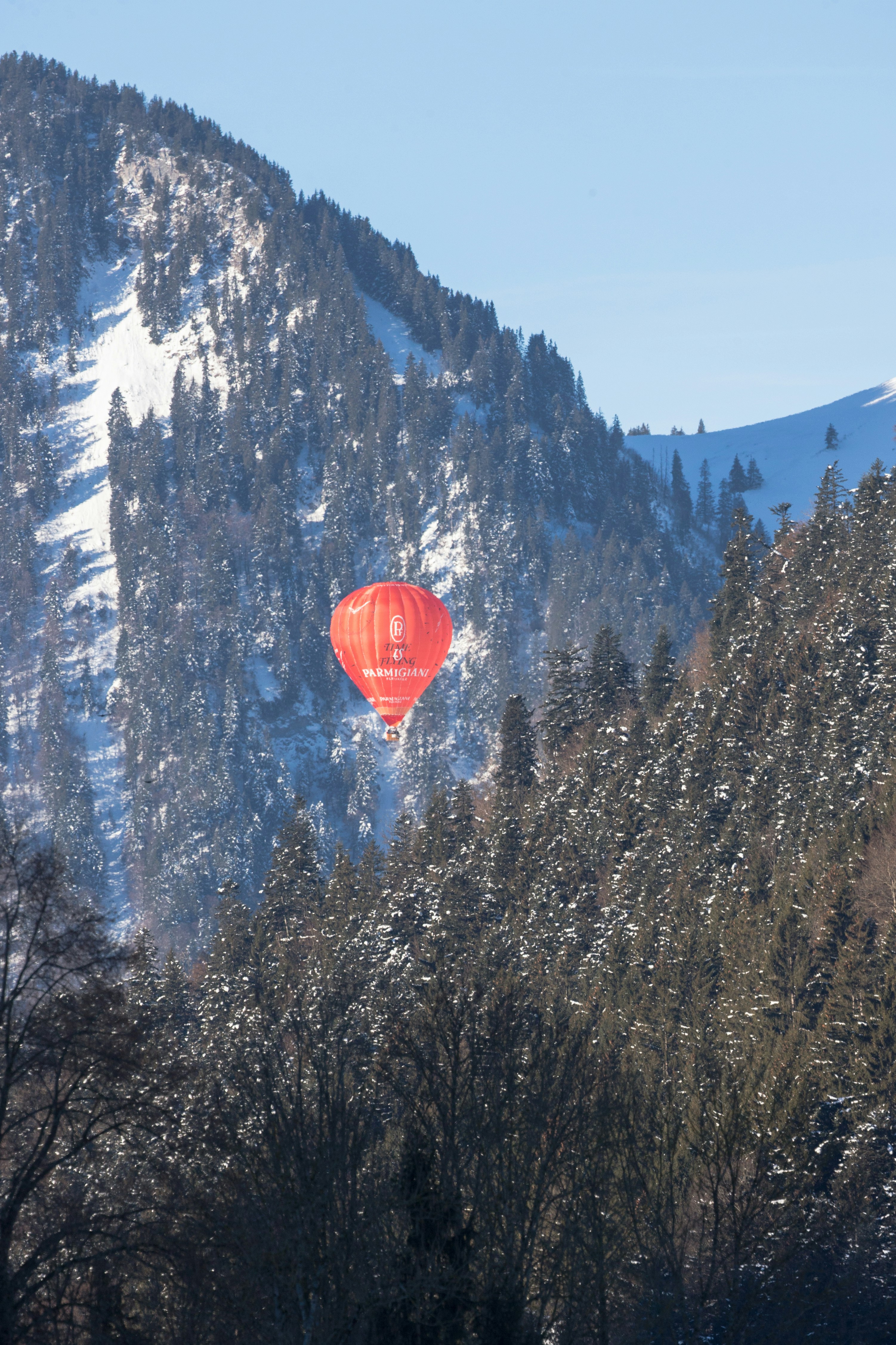 Red air balloon between green mountains with trees photo – Free Balloon ...