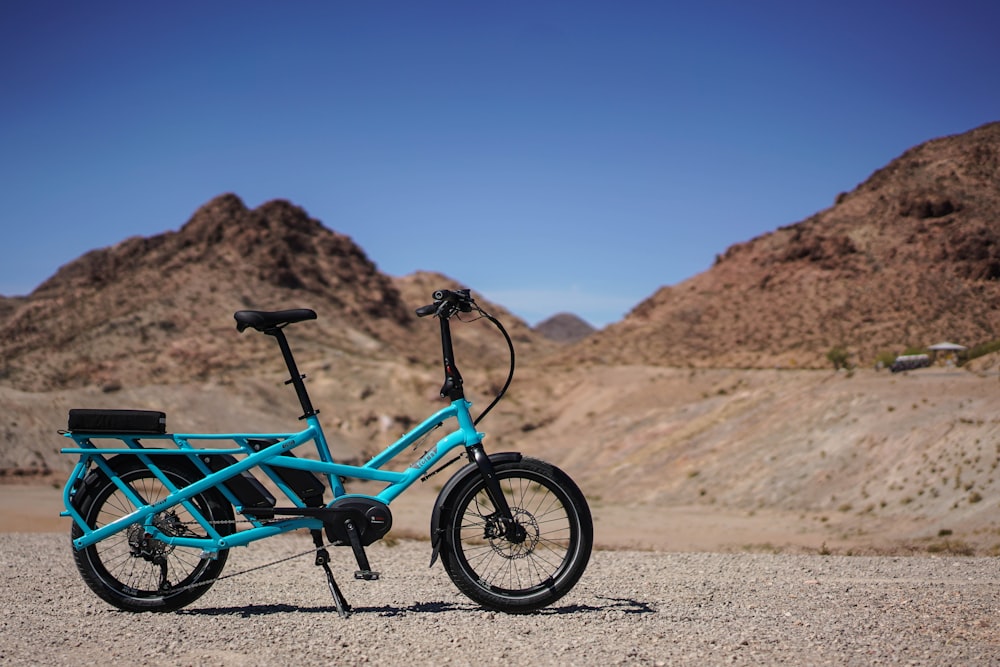 blue bicycle near mountain