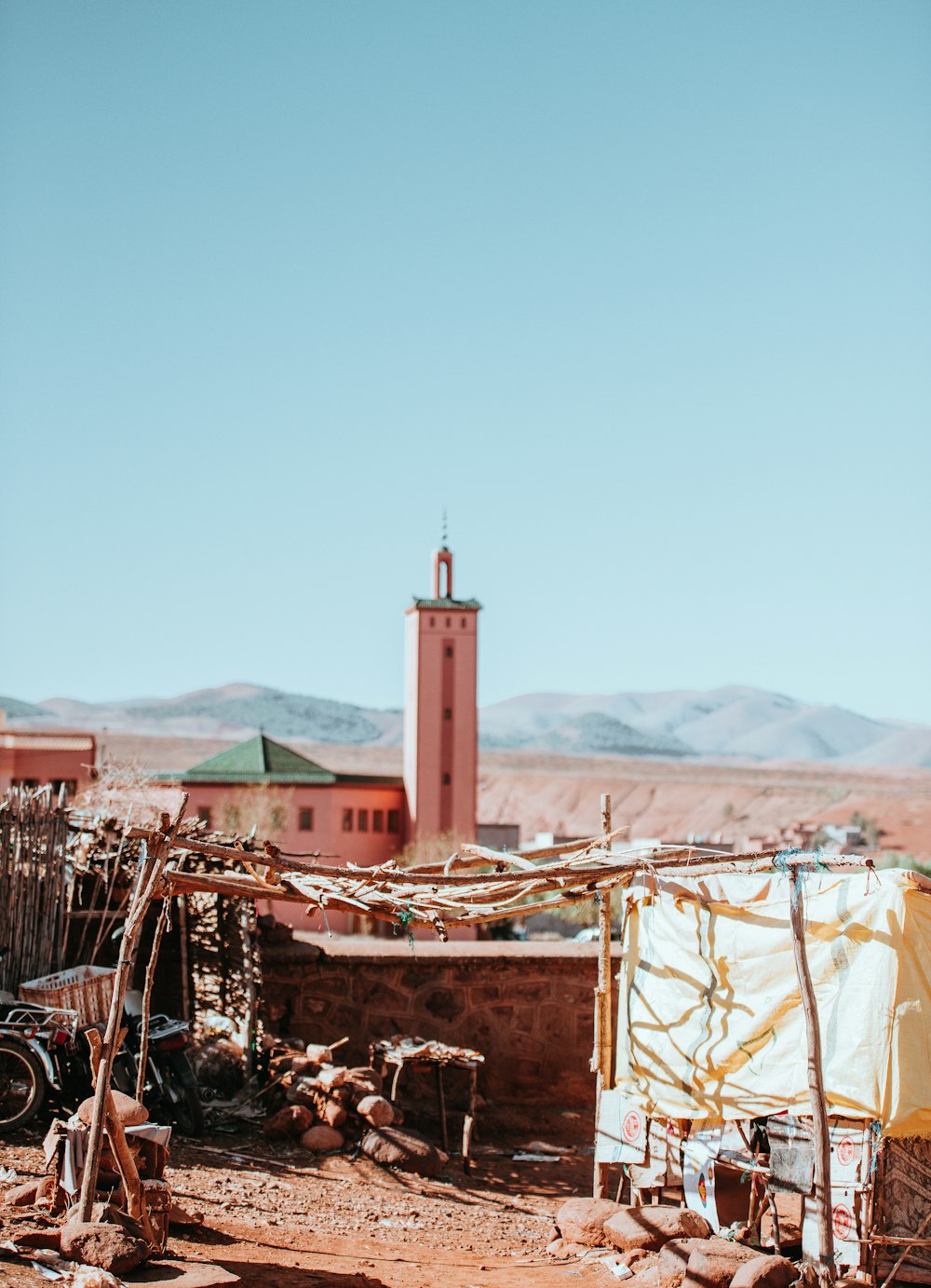 a small building with a clock tower in the background