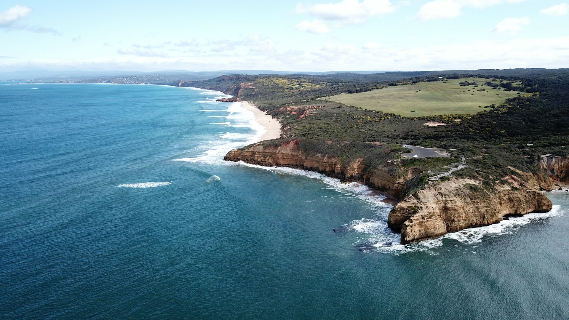 woman wearing yellow long-sleeved dress under white clouds and blue sky during daytime