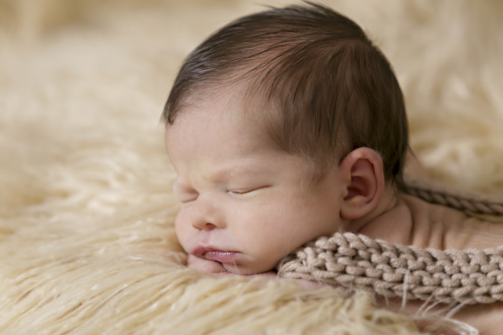 baby inside of beige and brown cloth