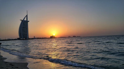 Golden sunset casting warm light over the elegant beachside terrace of Aurelia Mare.