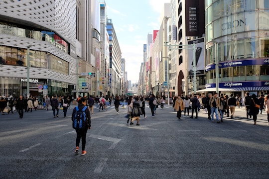 A bustling city street with people wearing The Lion Busness clothing in everyday life.