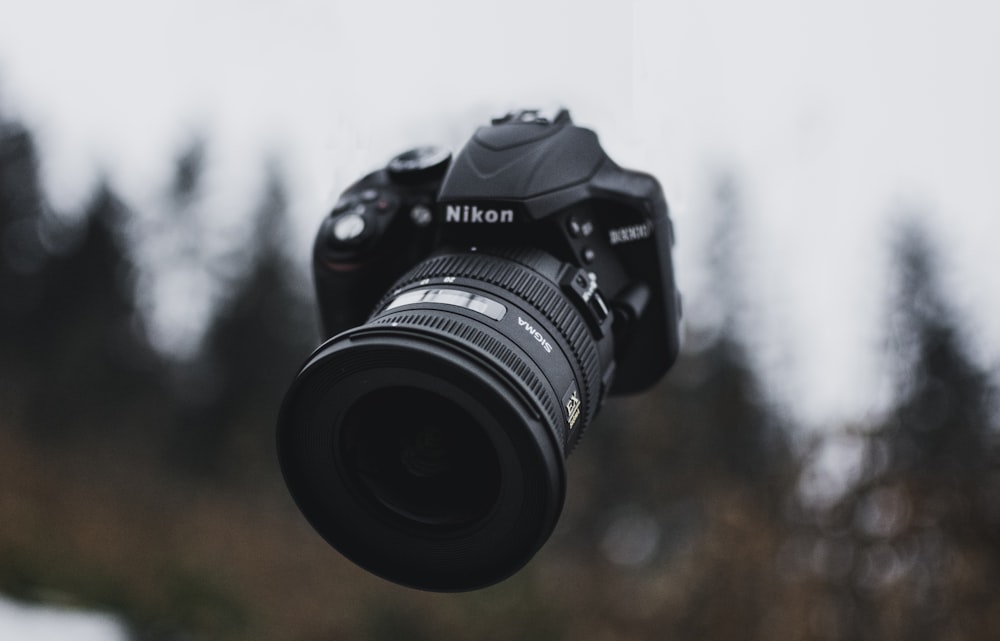 black Nikon DLSR camera