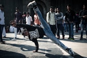 Breakdancers showcasing their skills on the street.